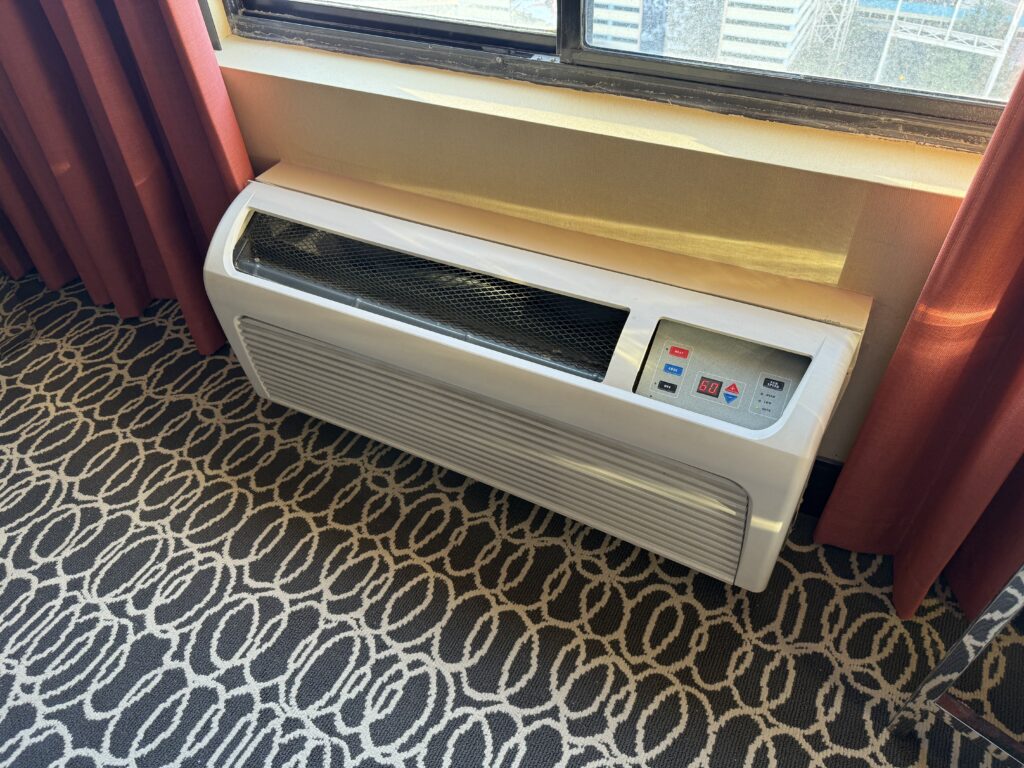 The air conditioning unit underneath the window in the room. 