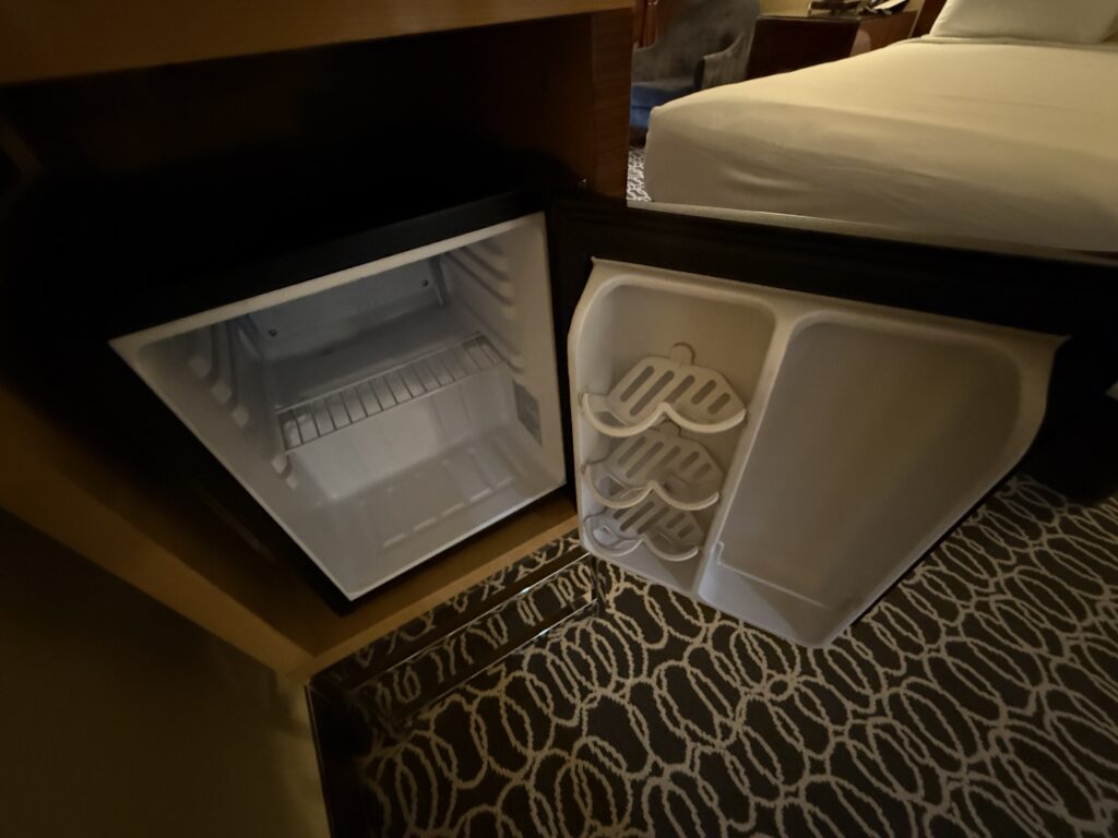 An open, empty mini fridge.