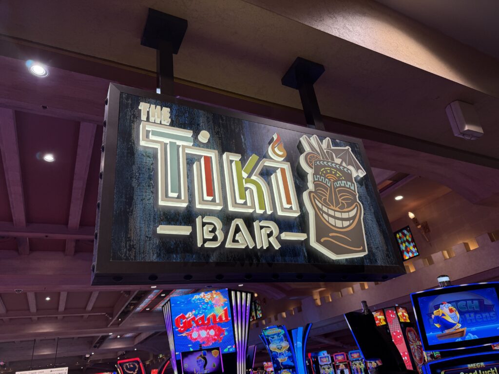 Sign for the Tiki Bar hanging from the ceiling. 