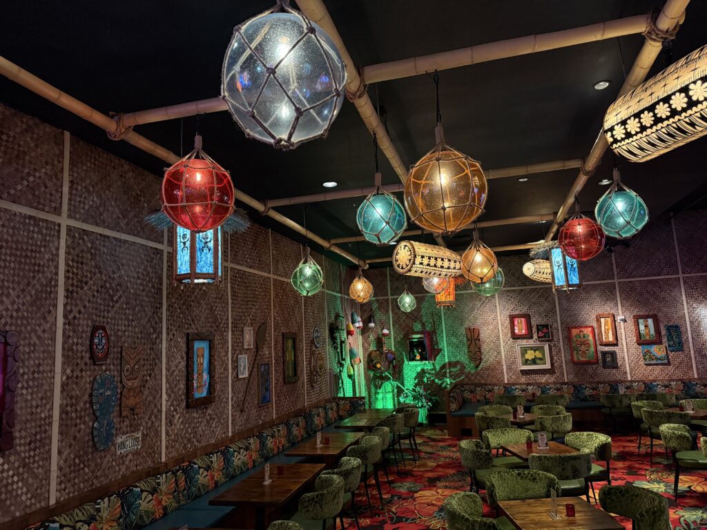 Illuminated light fixtures hanging from the ceiling in the Tiki Bar. 