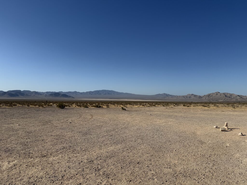 A sandy dry lake bed is barely visible between the foreground and the mountains in the background.