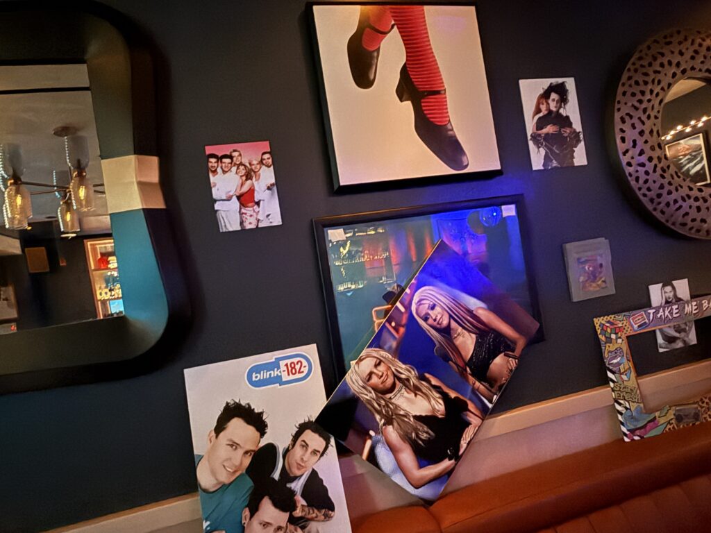 A collage of movie, and music wall decor hung to resemble a collage.