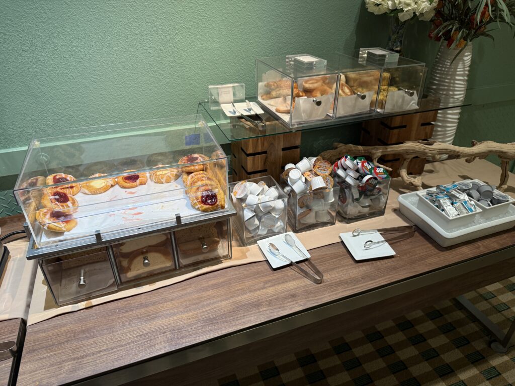 A clear plastic case stocked with assorted baked goods. 