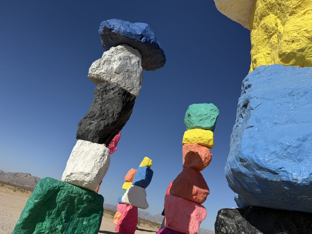 SEveral stacks of colorful rocks, some casting shadows on the others.
