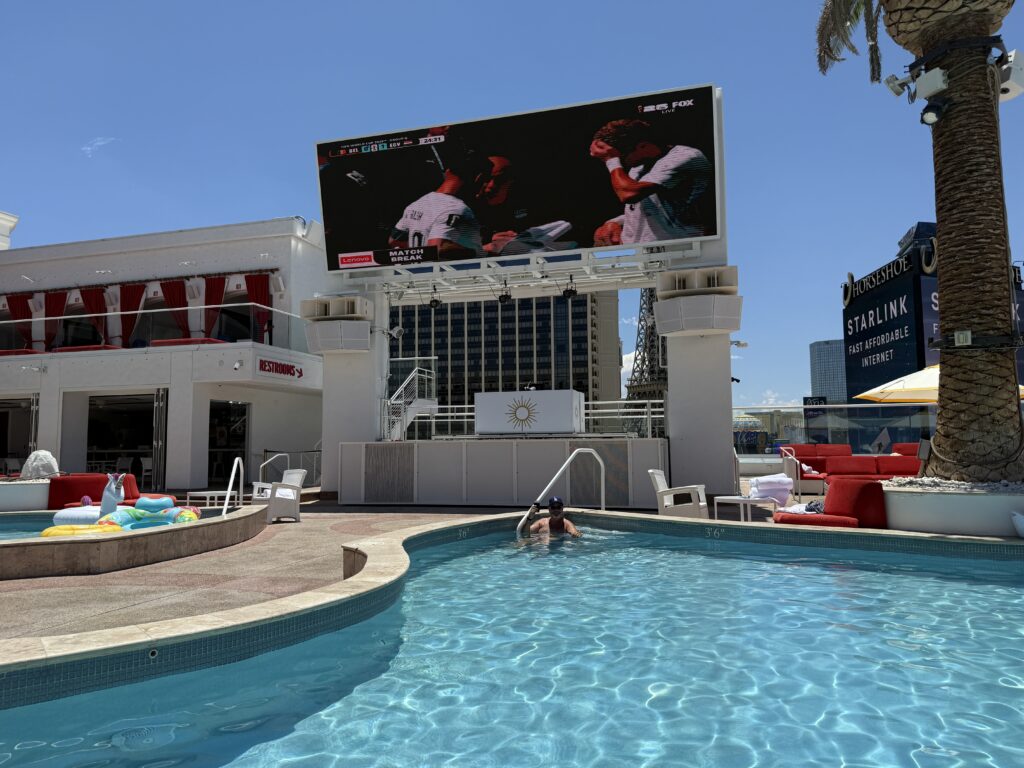 A poolside tv playing soccer. 