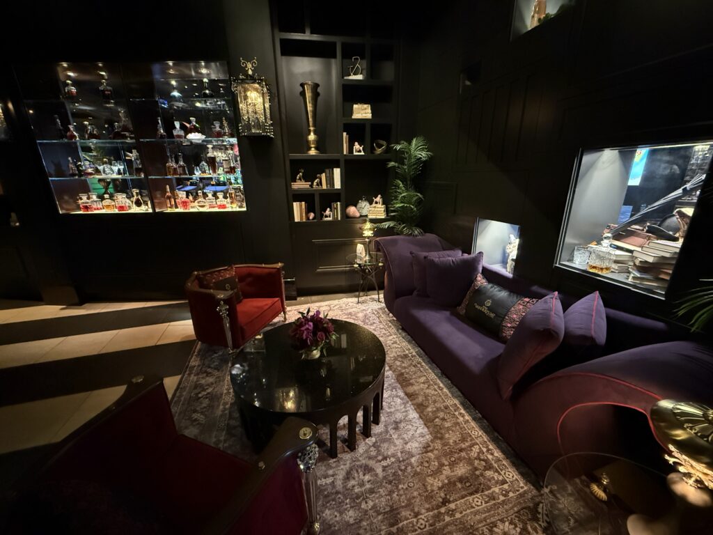 Dark furnishings and wall decor in the Vanderpump hotel lobby. 