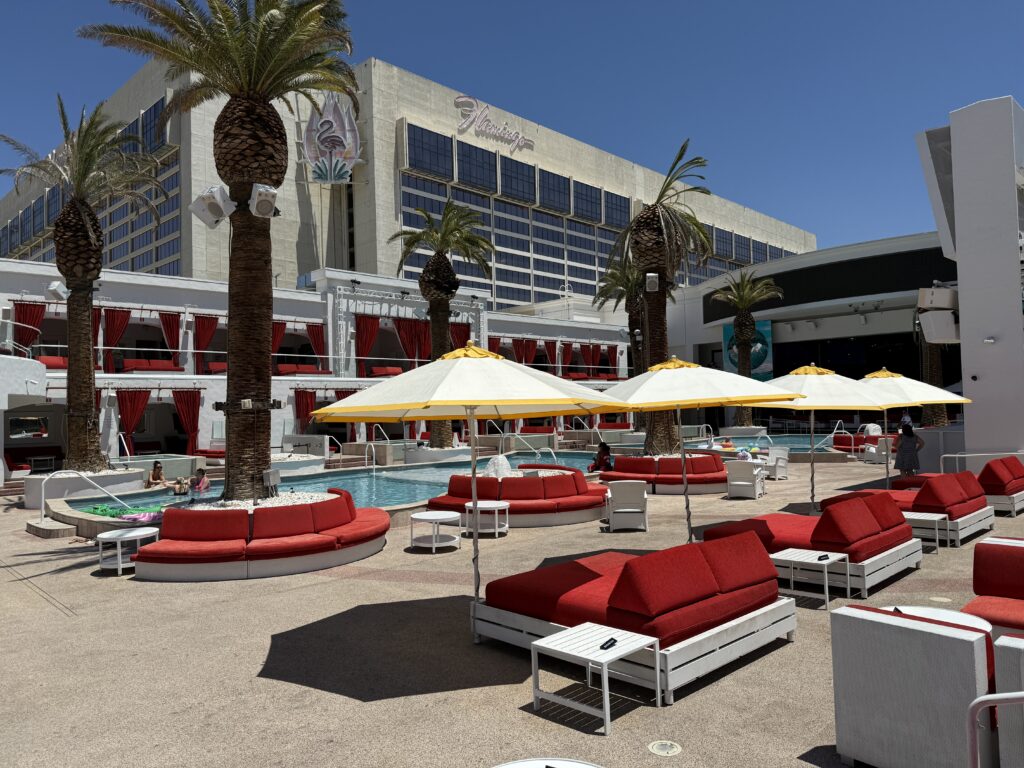 An angle of the pool that shows The Flamingo in the background. 
