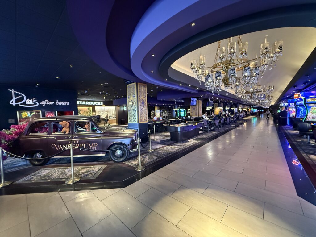 The casino floor, showing a the Vanderpump car parked in front of table games. 