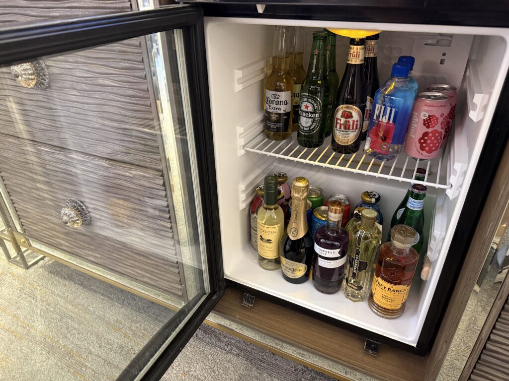 Refrigerated minibar stocked with beverages. 