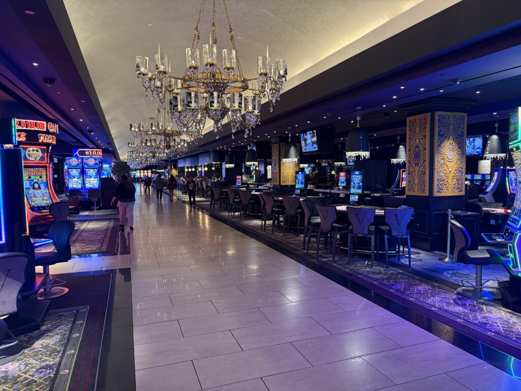 A row of chandeliers down the center isle of the casino.