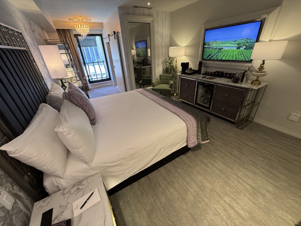 Another angle of the room that shows the bed pointed at  the wall mounted TV. 