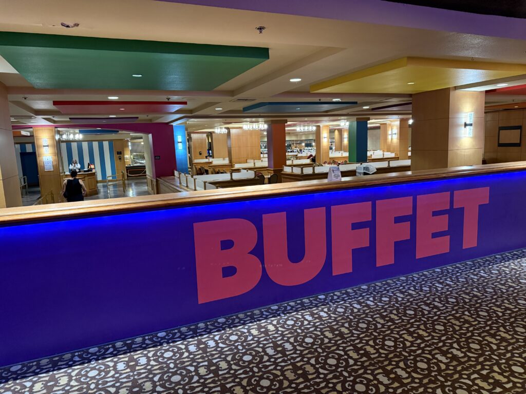 Exterior of the buffet space of Circus Circus. A wall is in the foreground that says "BUFFET".