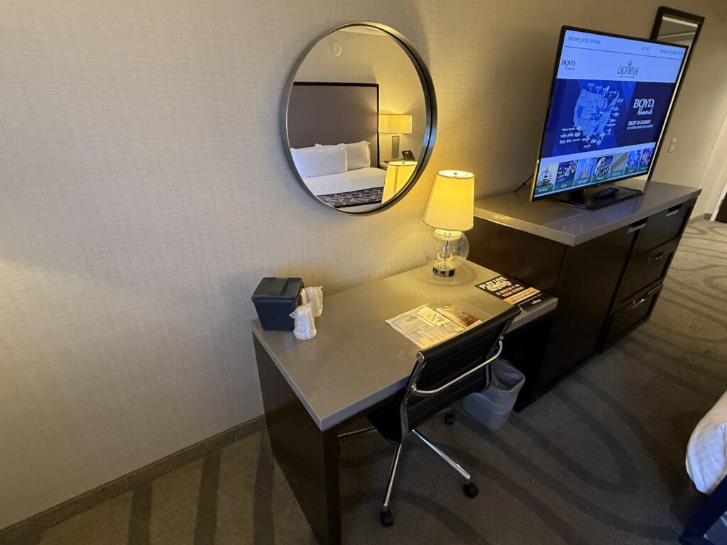 A work desk with rolling chair pushed in. 