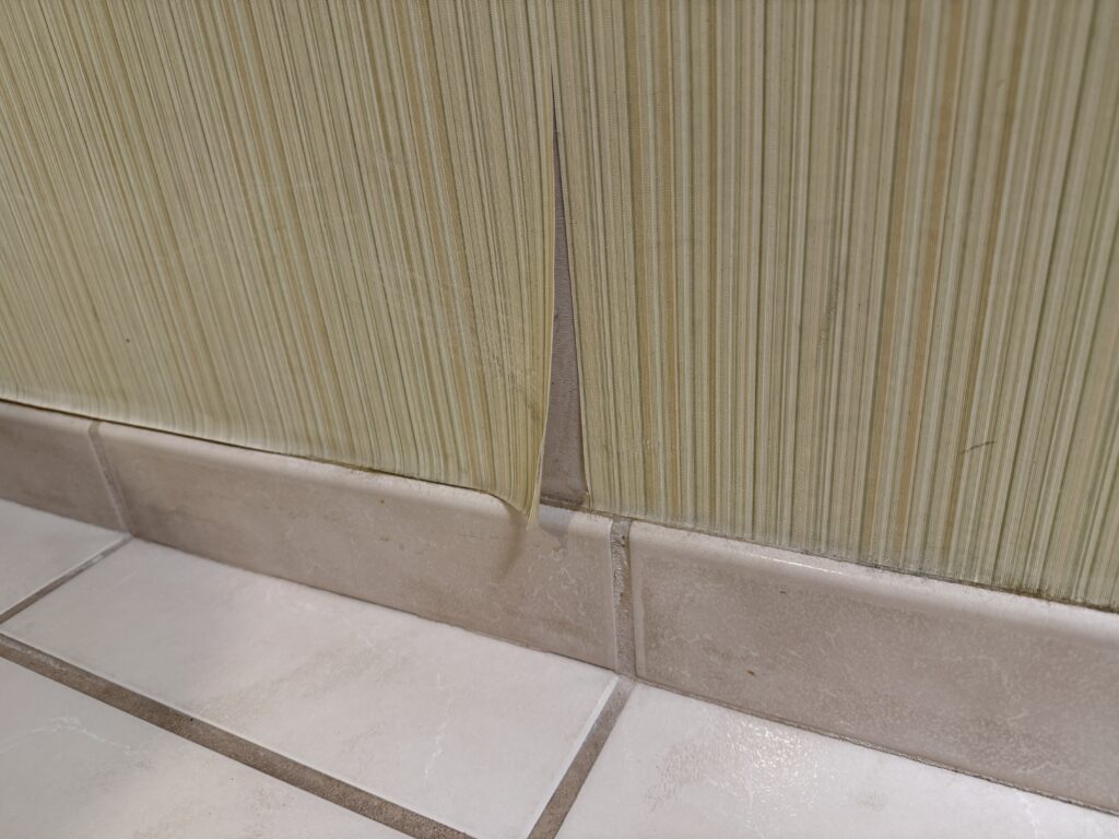 Peeling wallpaper in the bathroom.