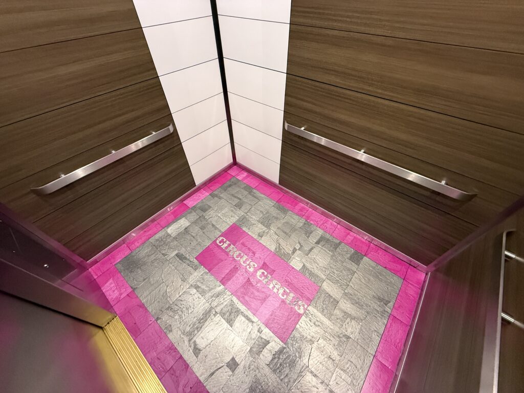 Inside an elevator, which is clearly new and has the Circus Circus logo on the floor.