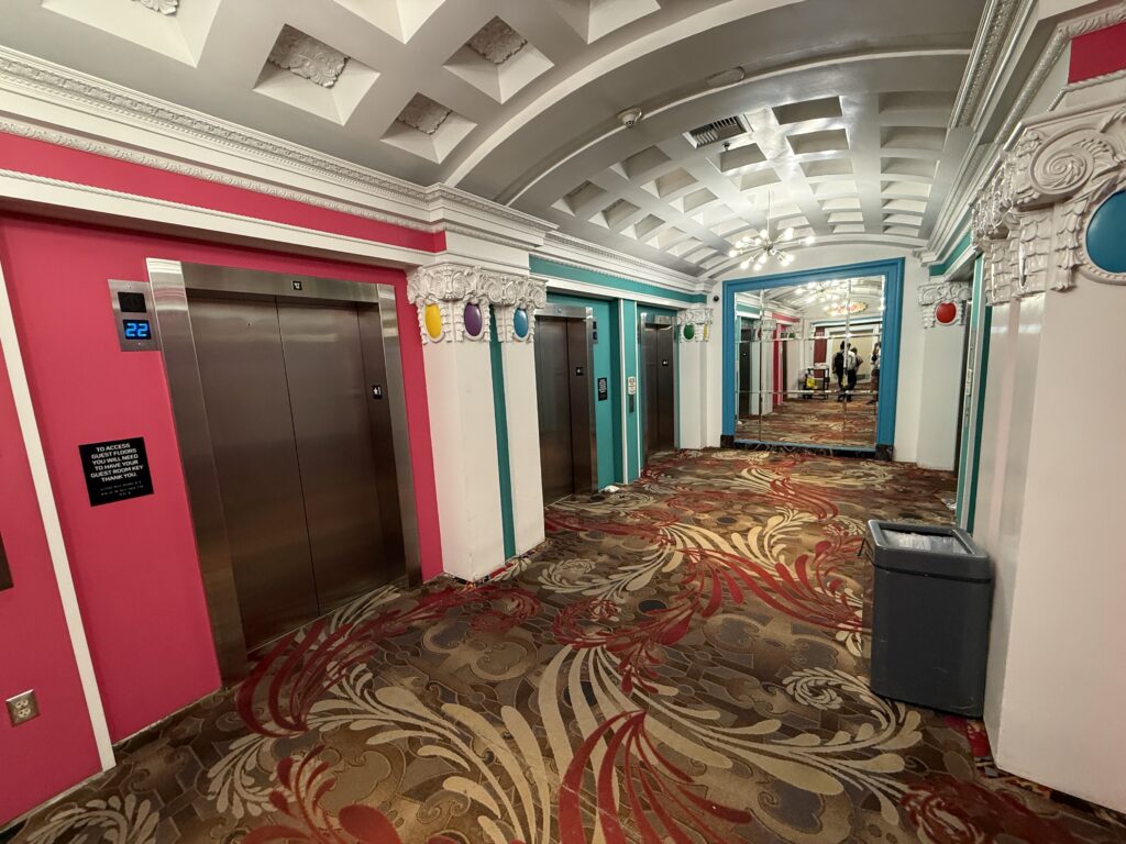 Main floor elevator lobby, which has pink and green trim.
