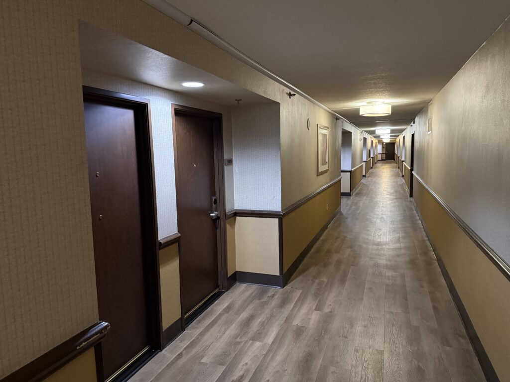Hotel hallway with faux wood flooring.