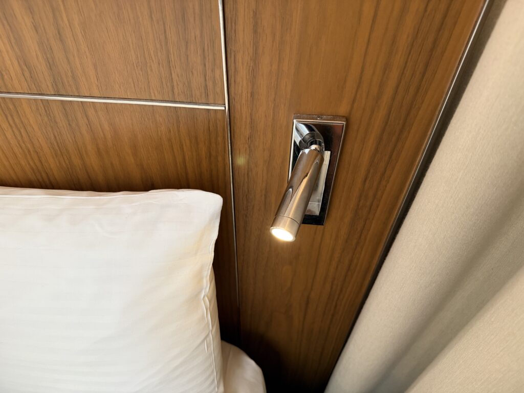 A reading light popping out of the headboard. 