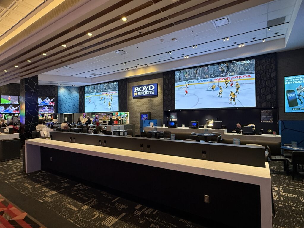 Large screens playing sports behind the bar. 