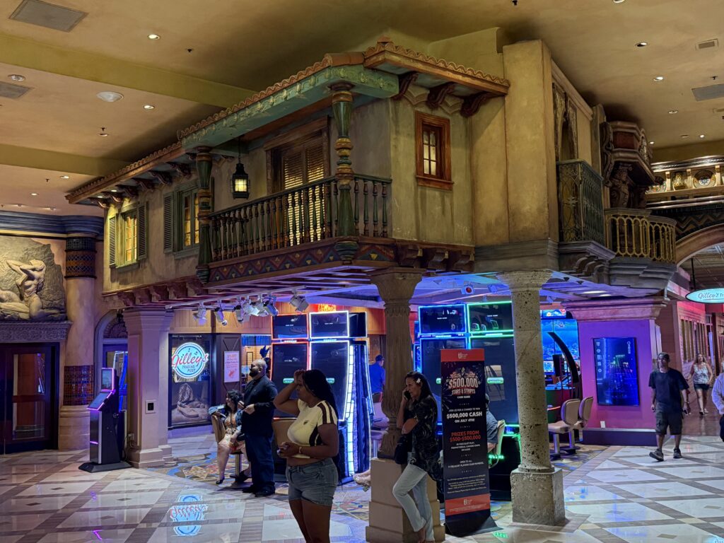 A mock pirate house above slot machines on the casino floor.