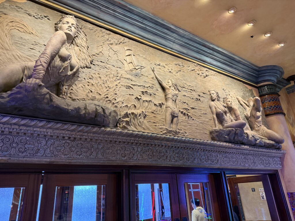 Intricate pirate themed carvings above one of the entrance doors to the casino.