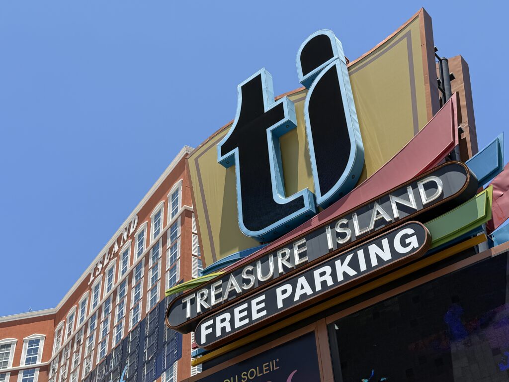 Close up of the TI sign, boasting free parking. The hotel tower is in the background.