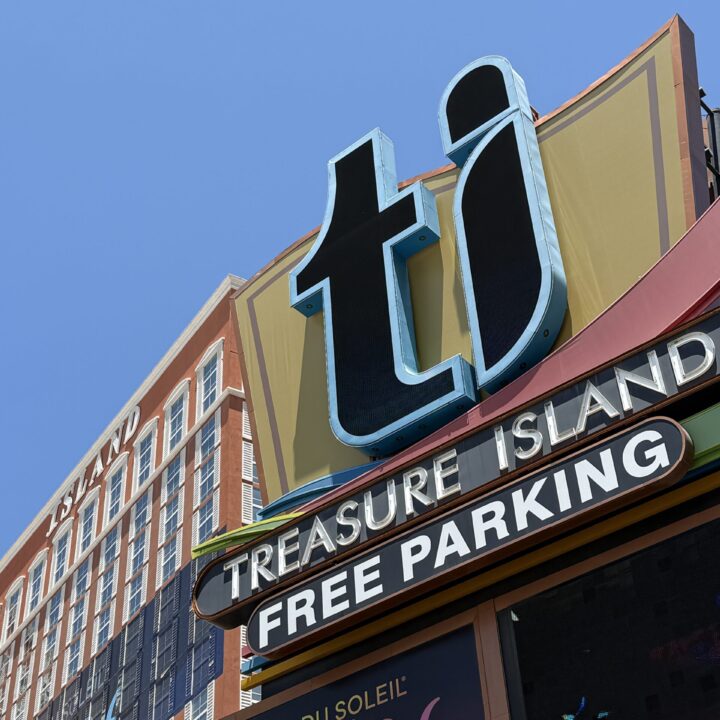 Close up of the TI sign, boasting free parking. The hotel tower is in the background.