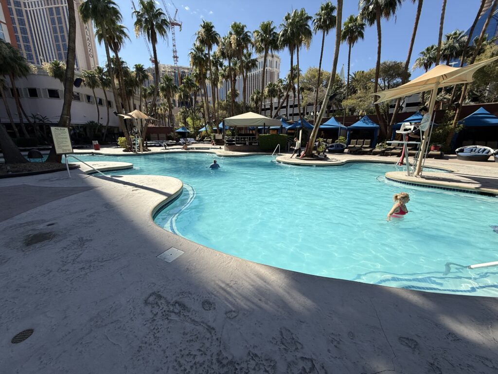 The pool at TI Las Vegas with a lone swimmer in it.