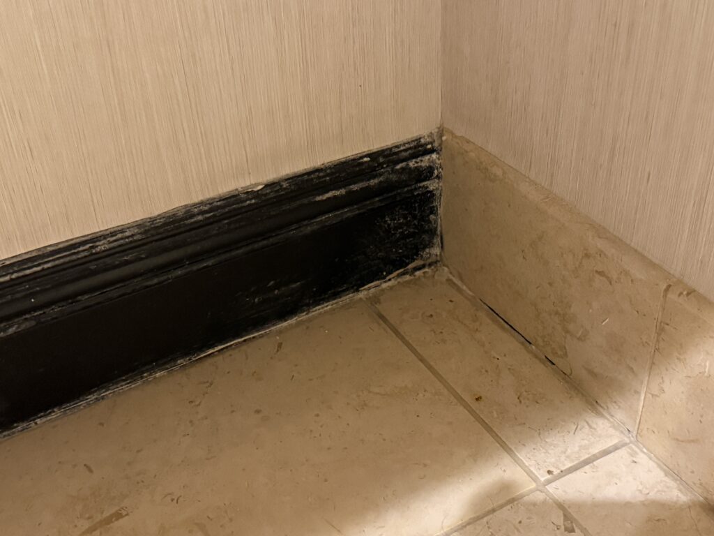 A brown, chipped baseboard.
