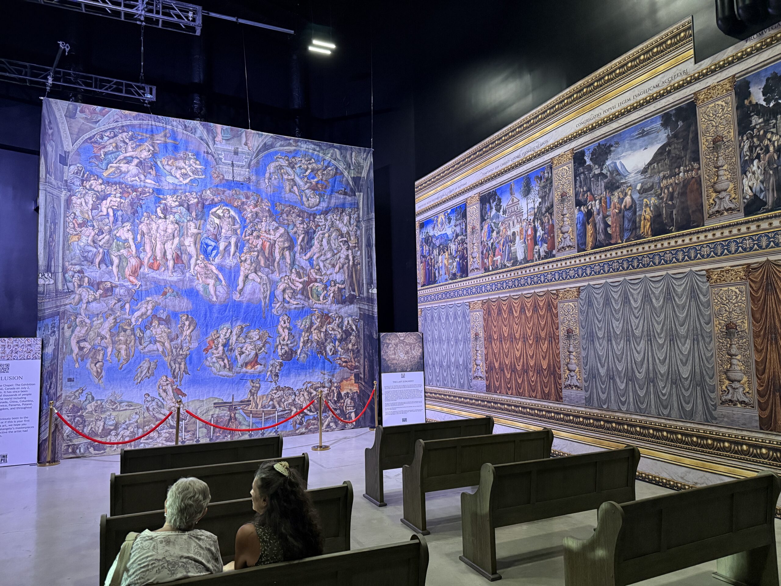 The Last Judgment fresco with pew seating pointing at it.