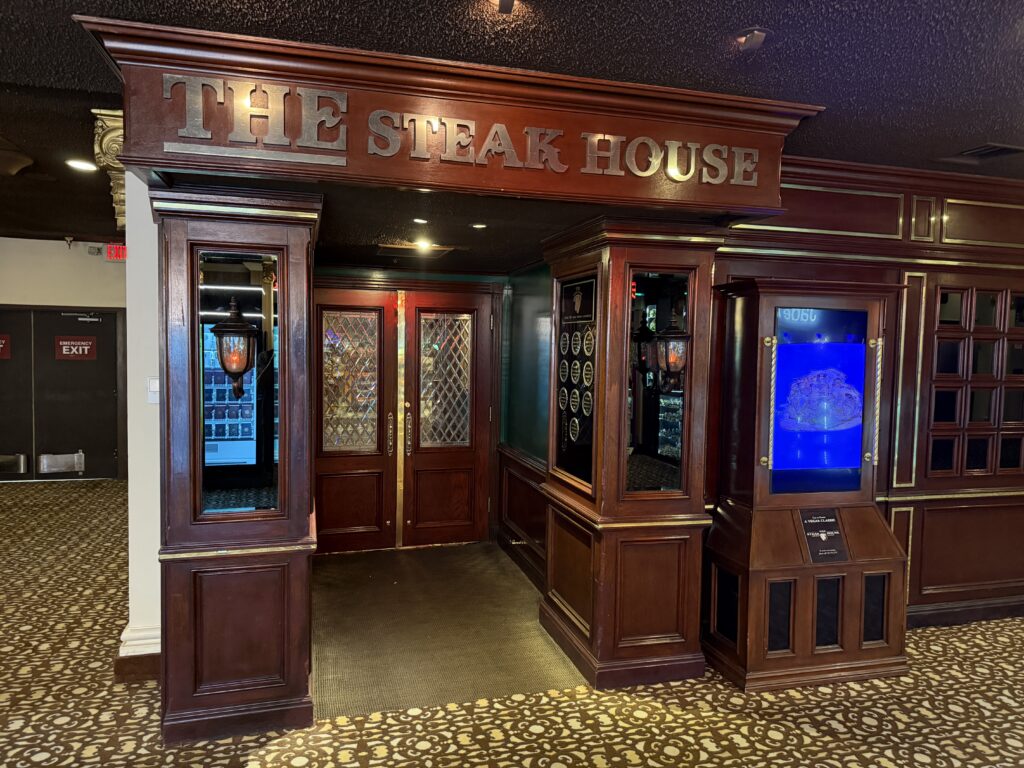 Exterior facade of The Steakhouse, which is made with dark wood.