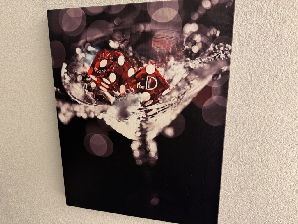 Wall art depicting dice from The D splashing into a martini glass.