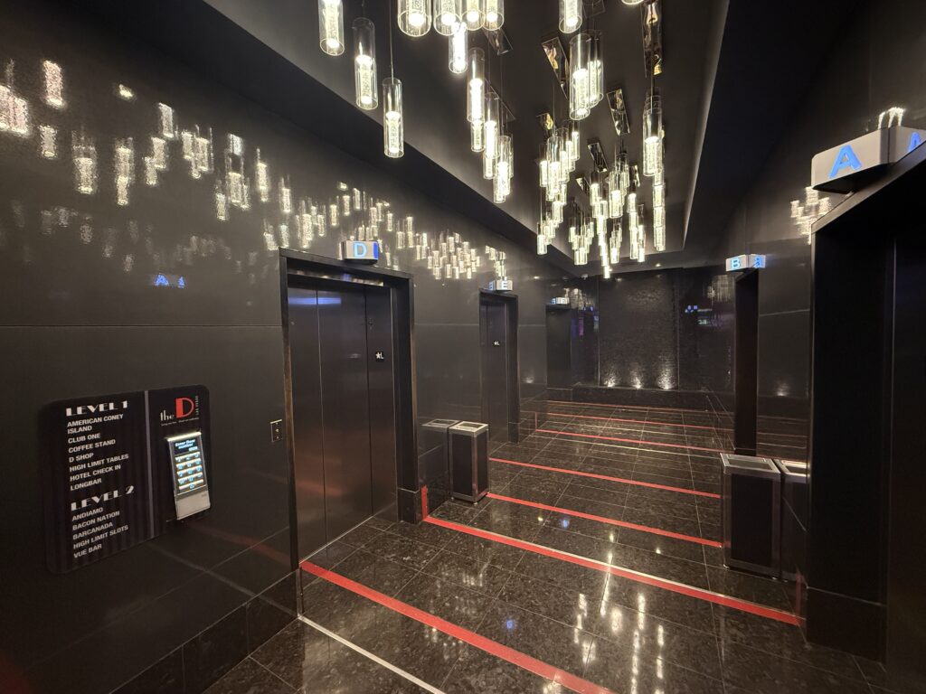 Main floor elevator lobby, with decorative old timey lightbulbs dangling from the ceiling.