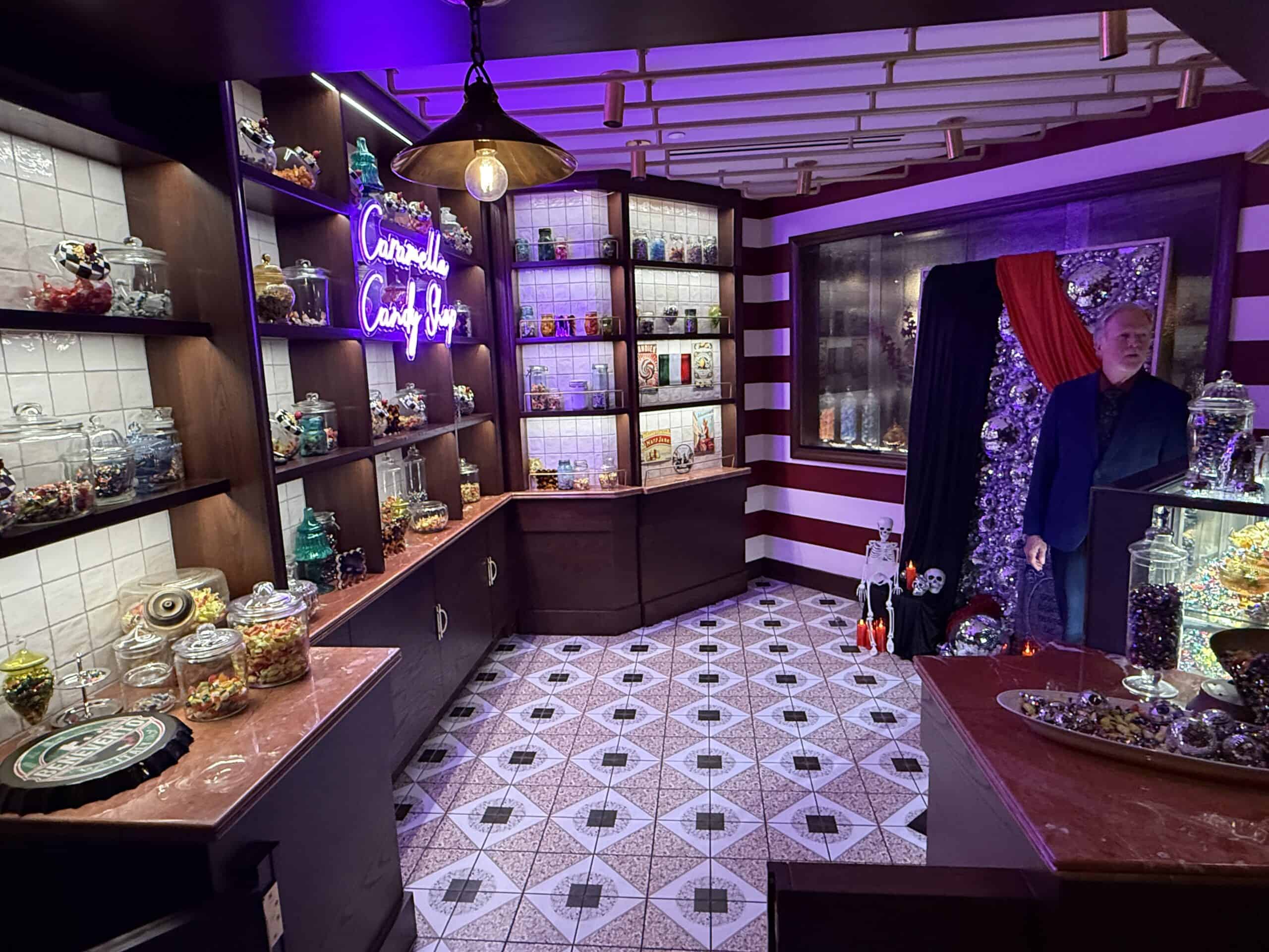 The entrance to the speakeasy, which is an illuminated candy shelving unit on the back wall.