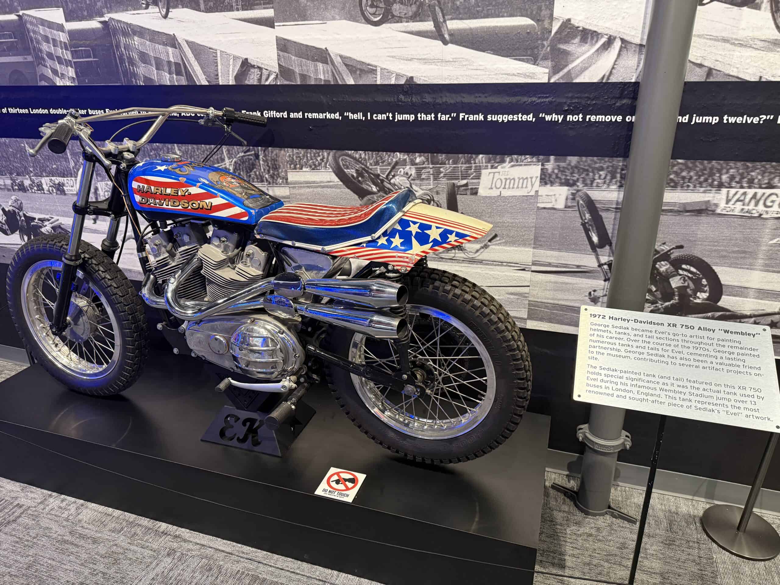A red, white, and blue Harley on display.