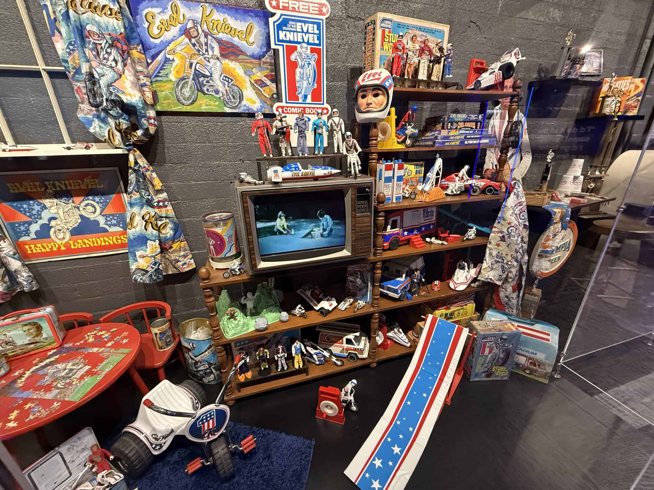 An assortment of Evel themed merchandise in a display case.