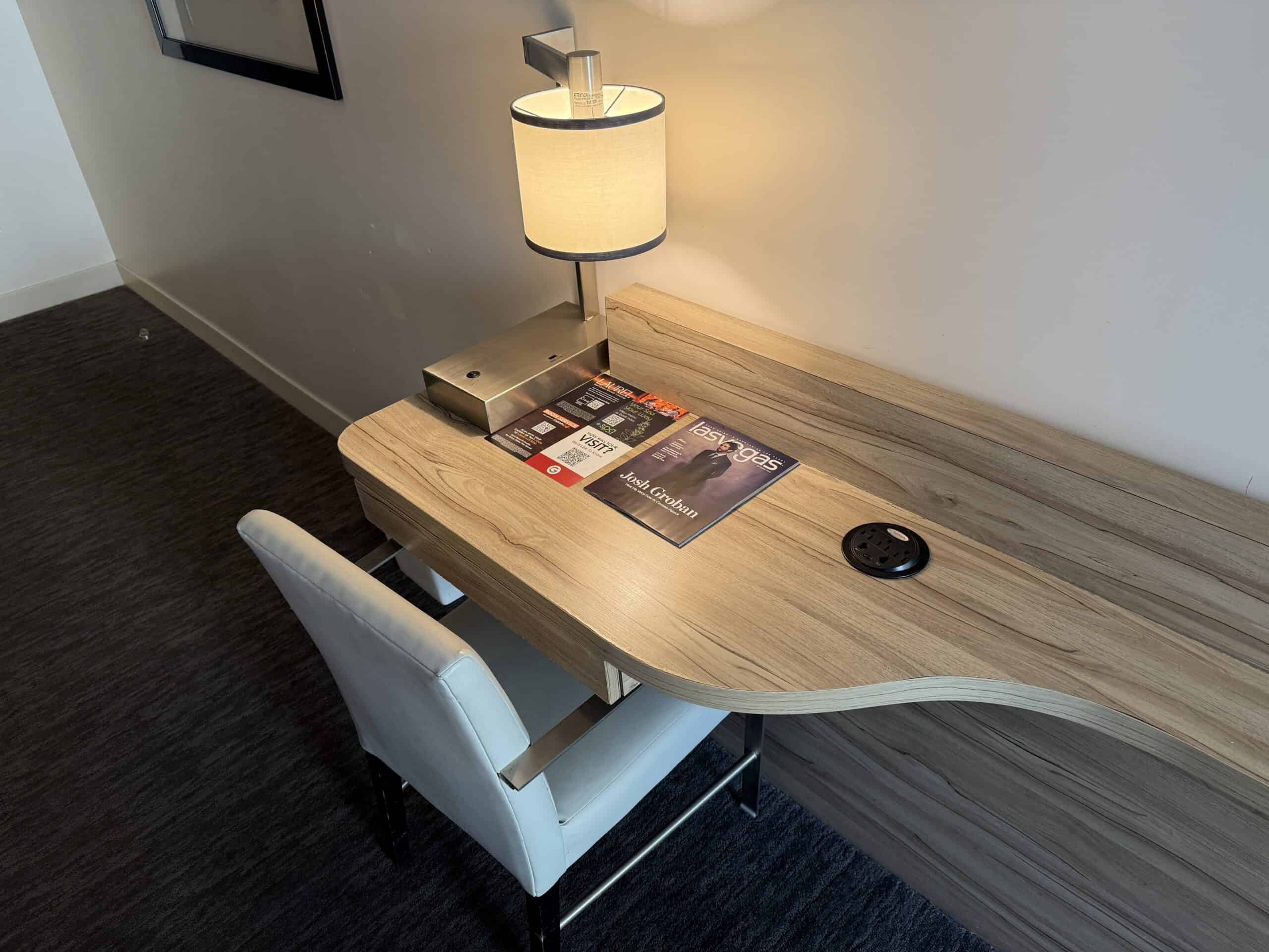 A basic work desk with a chair pushed in.