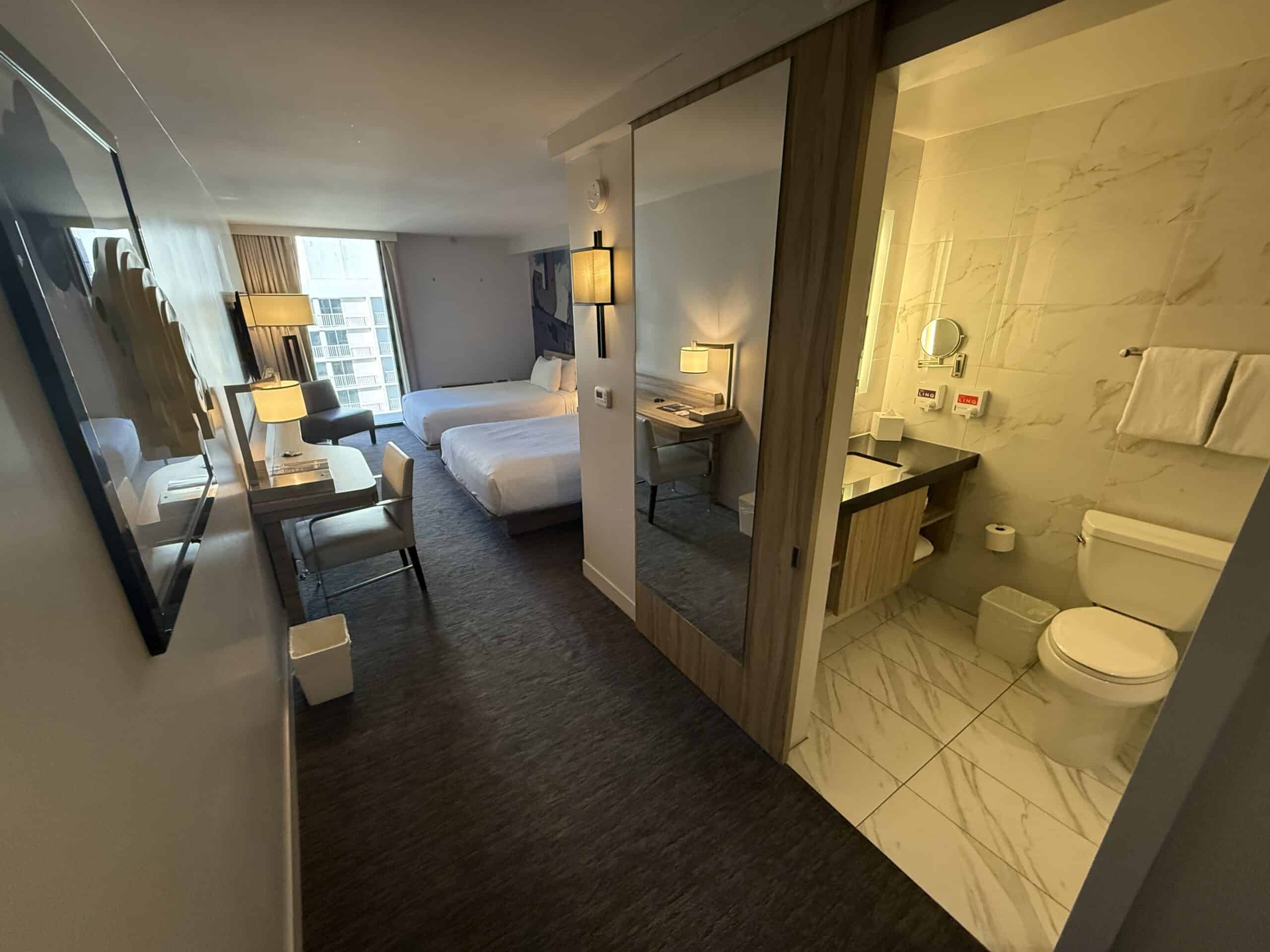 The entryway to the room, with the bathroom door to the right.