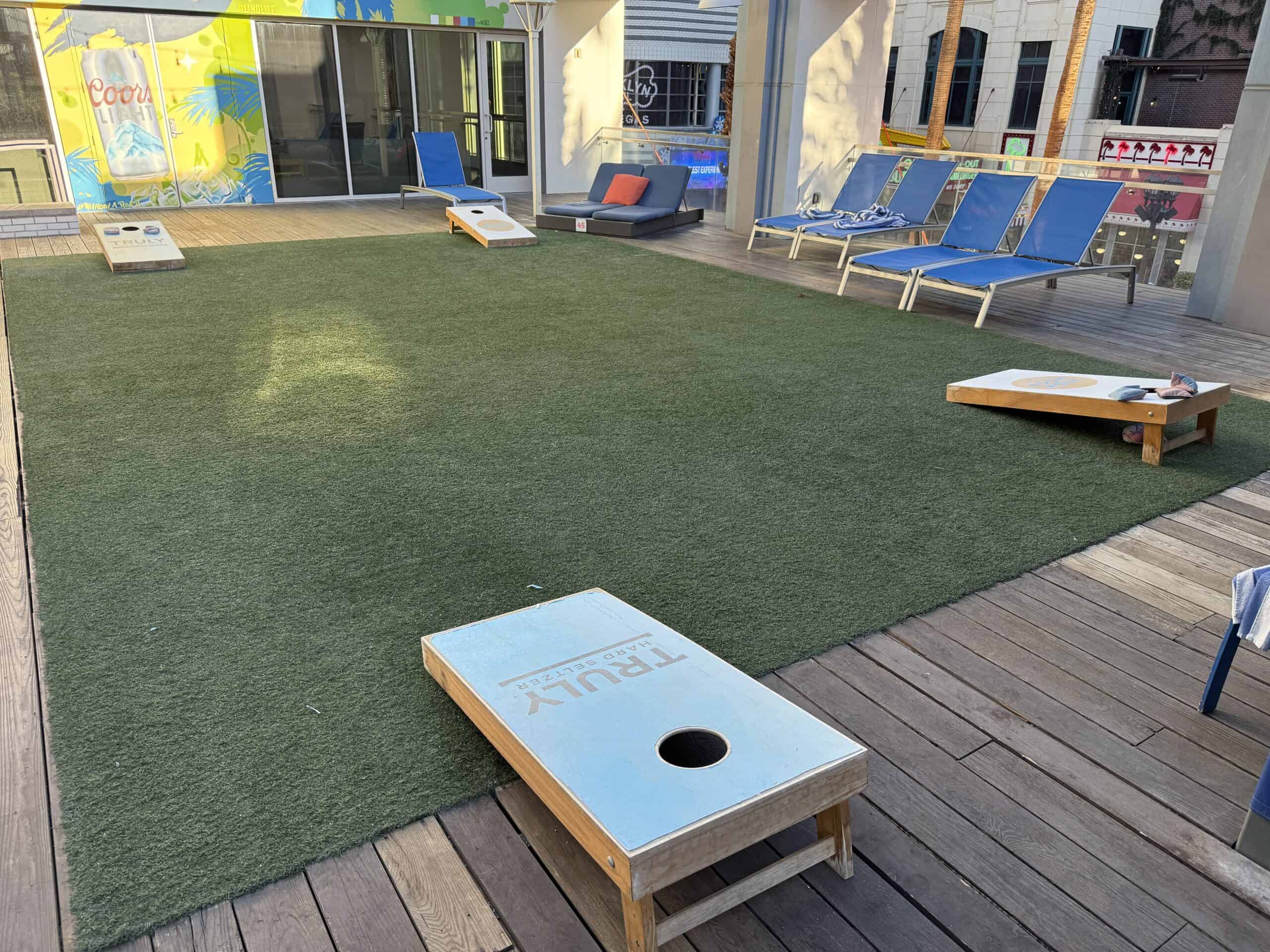 cornhole on turf on LINQ's pool deck.