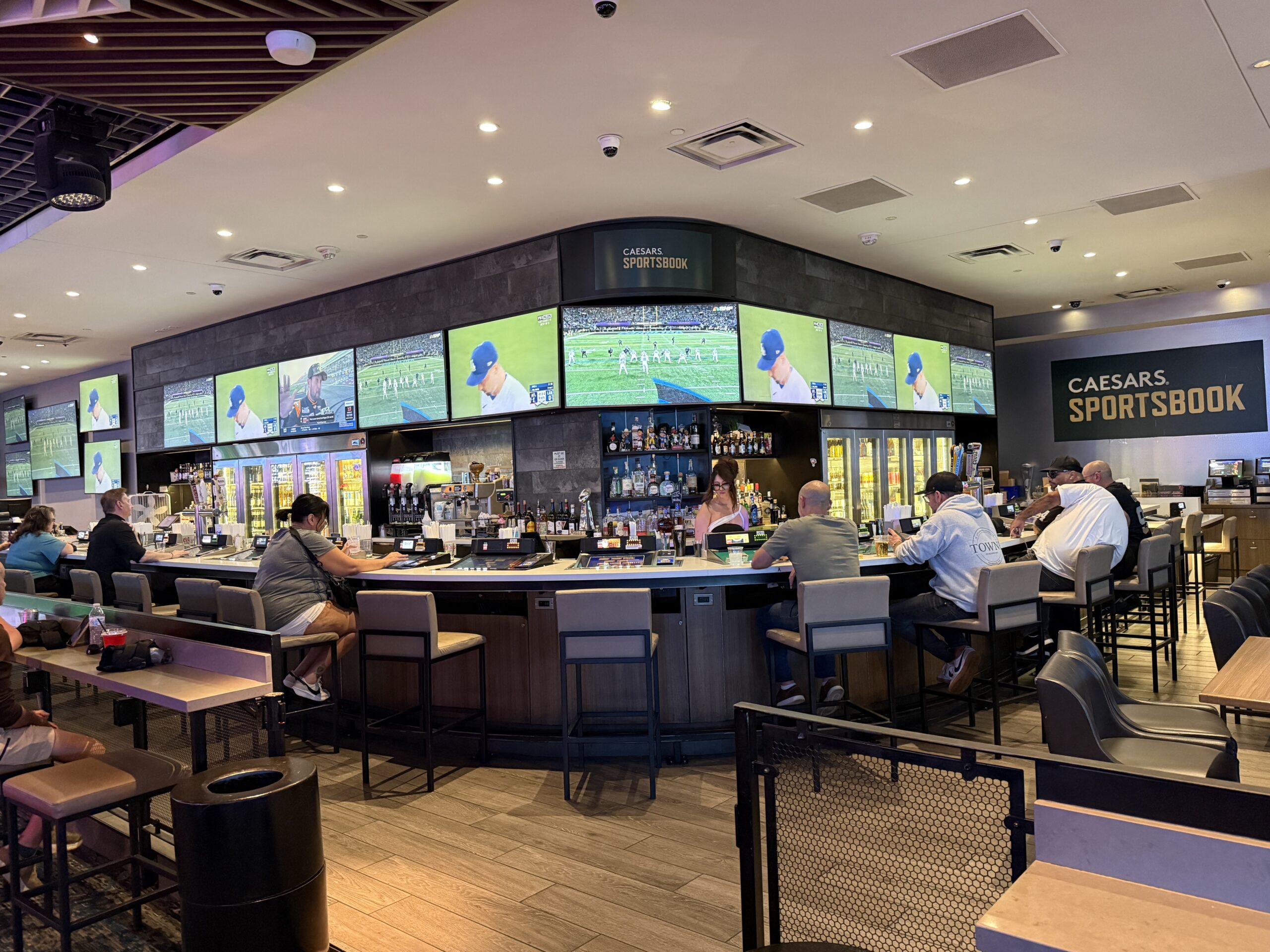 LINQ's sports bar, with screens above the bar playing the game.