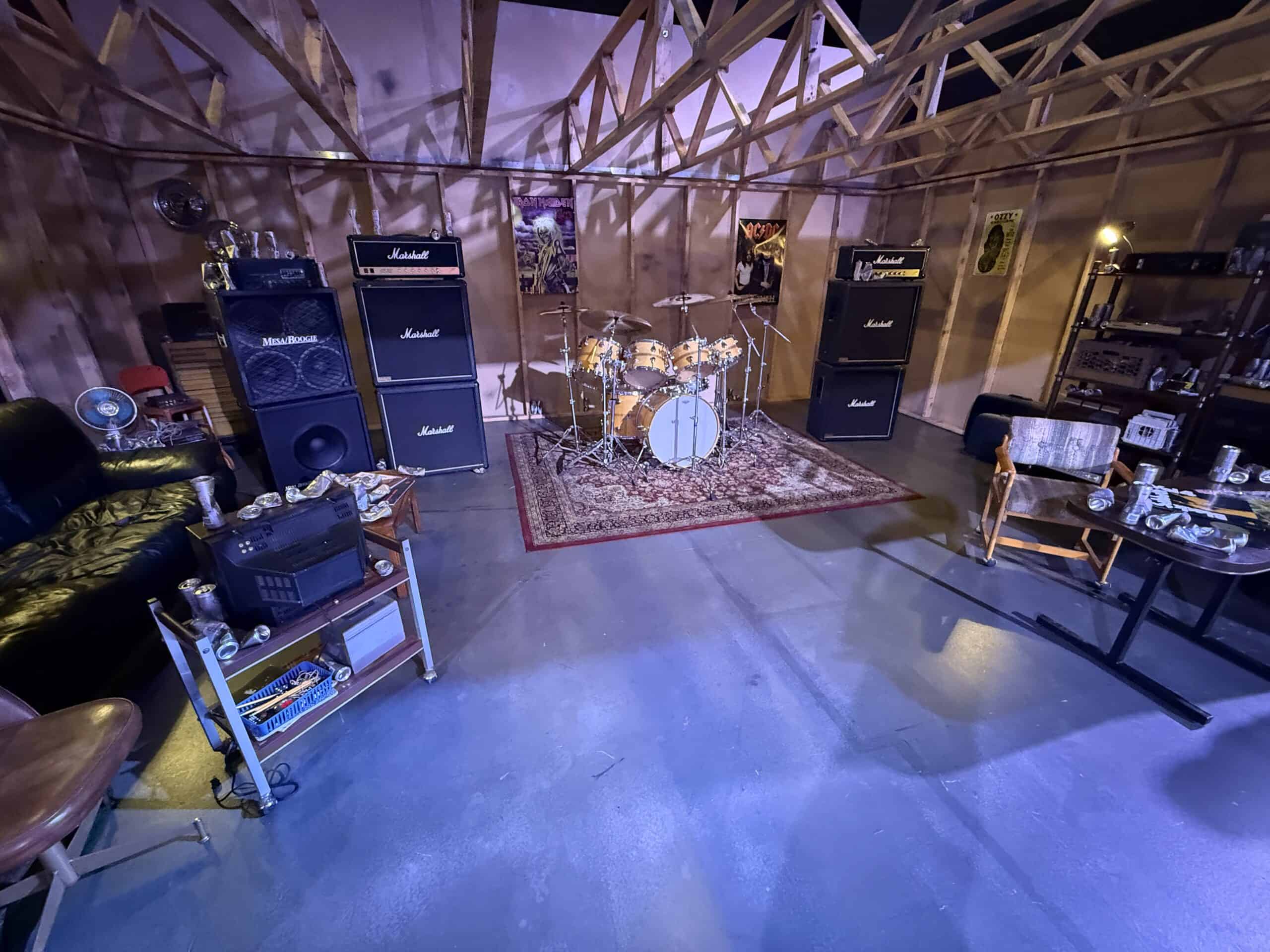 Replica "Early Days Garage", which has a drum set, guitars, and other items specific to the period.