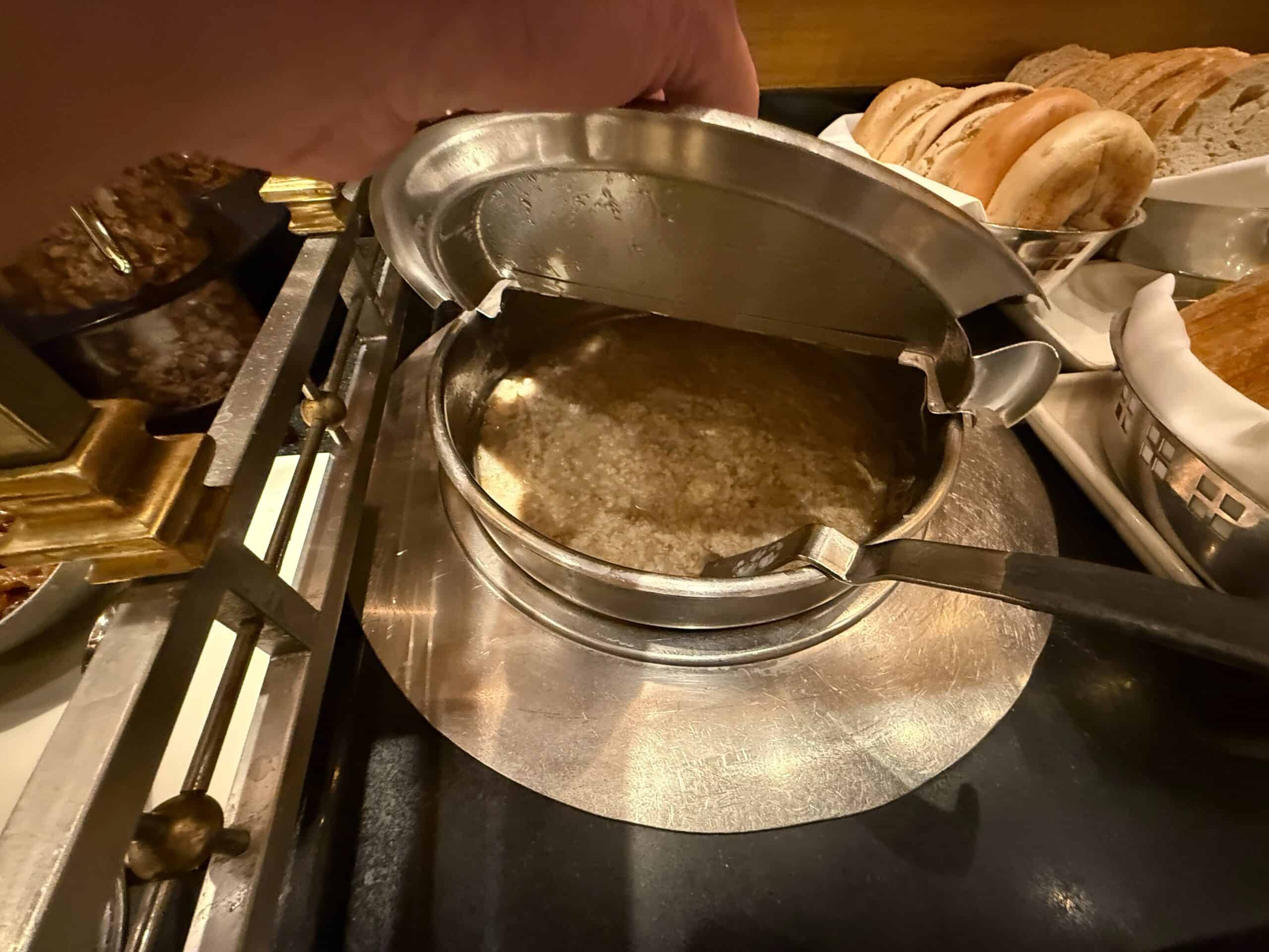 A tub of oatmeal in the cereal station of the buffet.