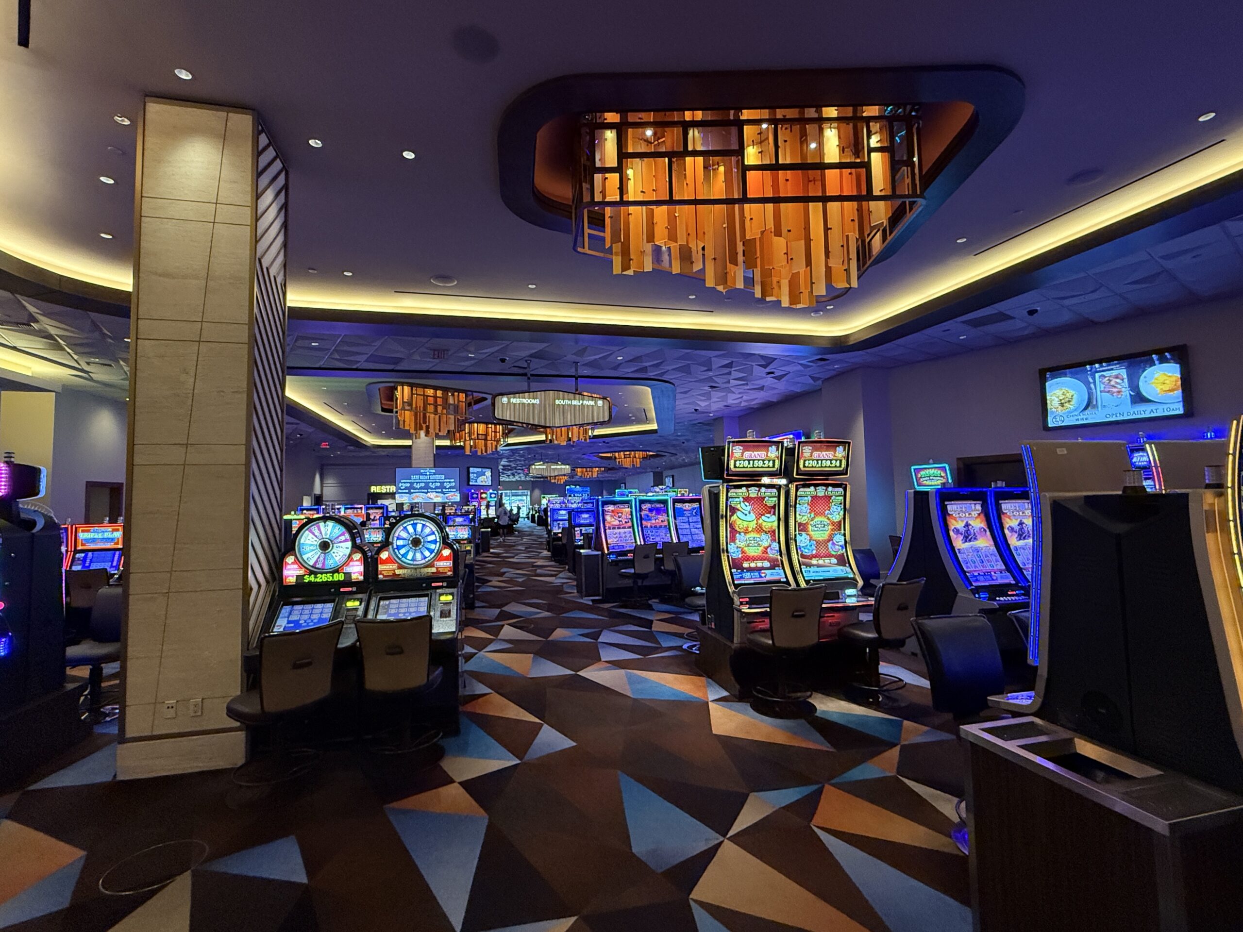 Slot machines line a walkway on Palace Station's casino floor.