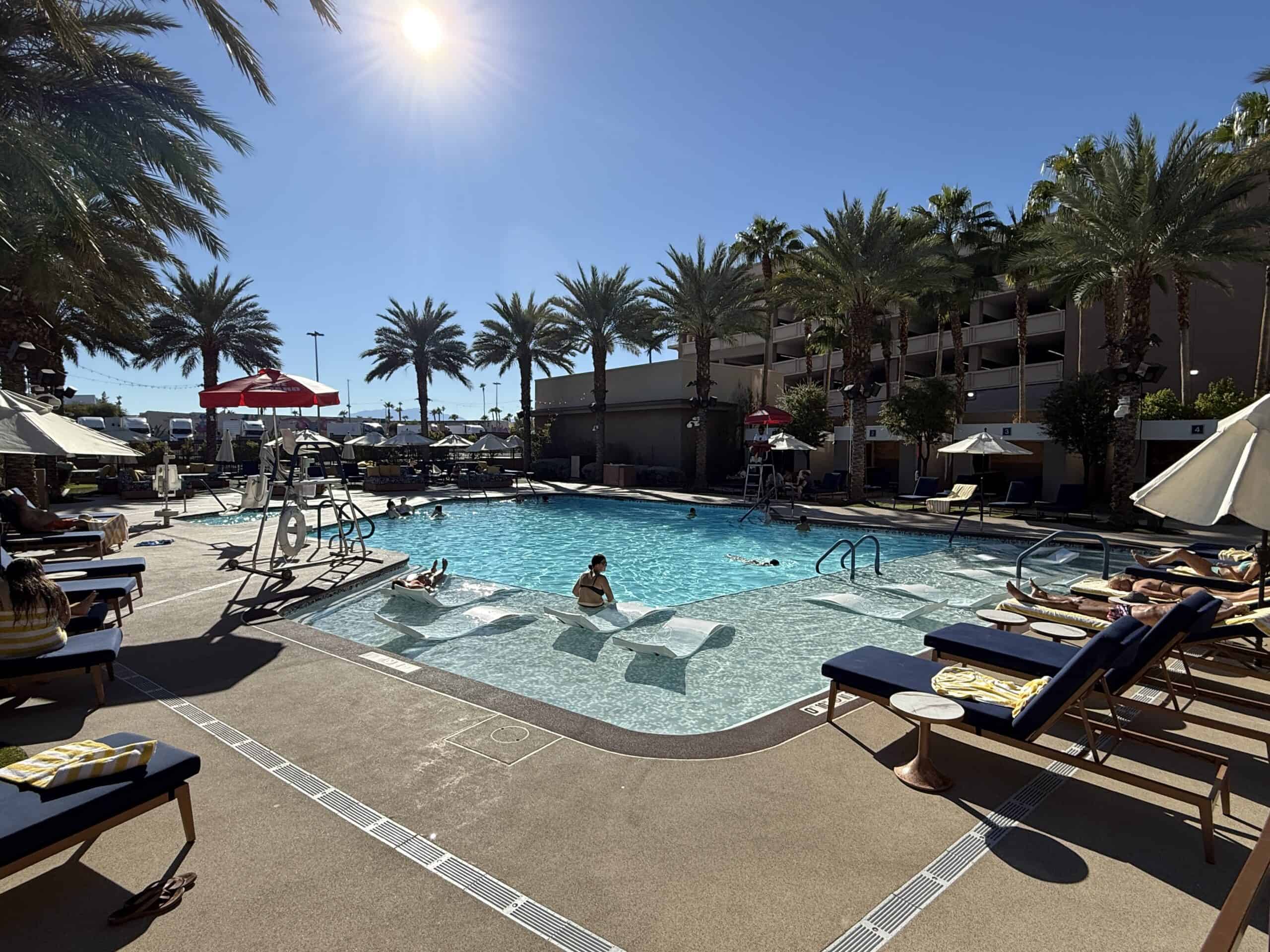 Another angle of the pool, with several loungers half submerged in water.