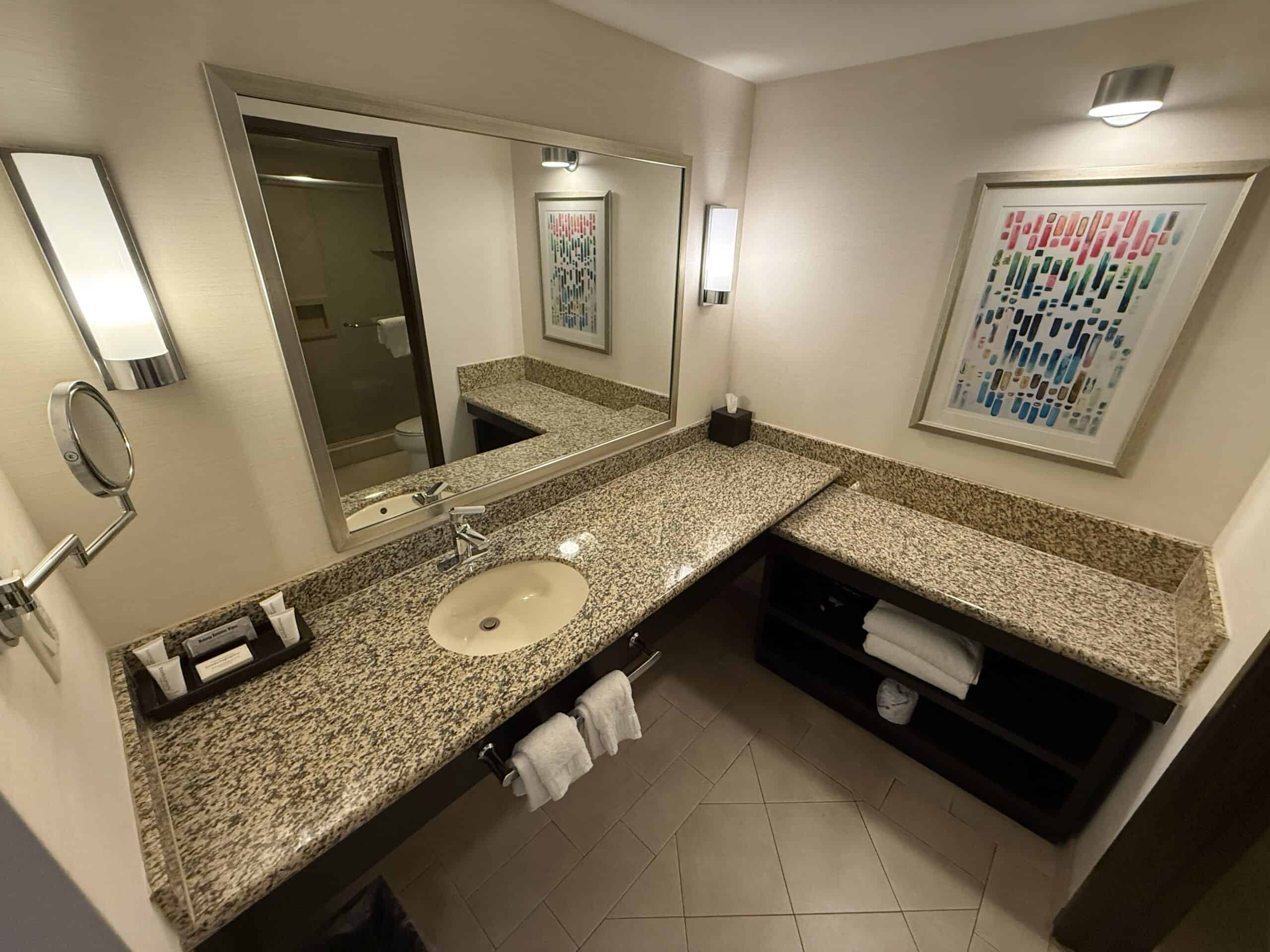 A single sink bathroom vanity with an L Shaped counter.