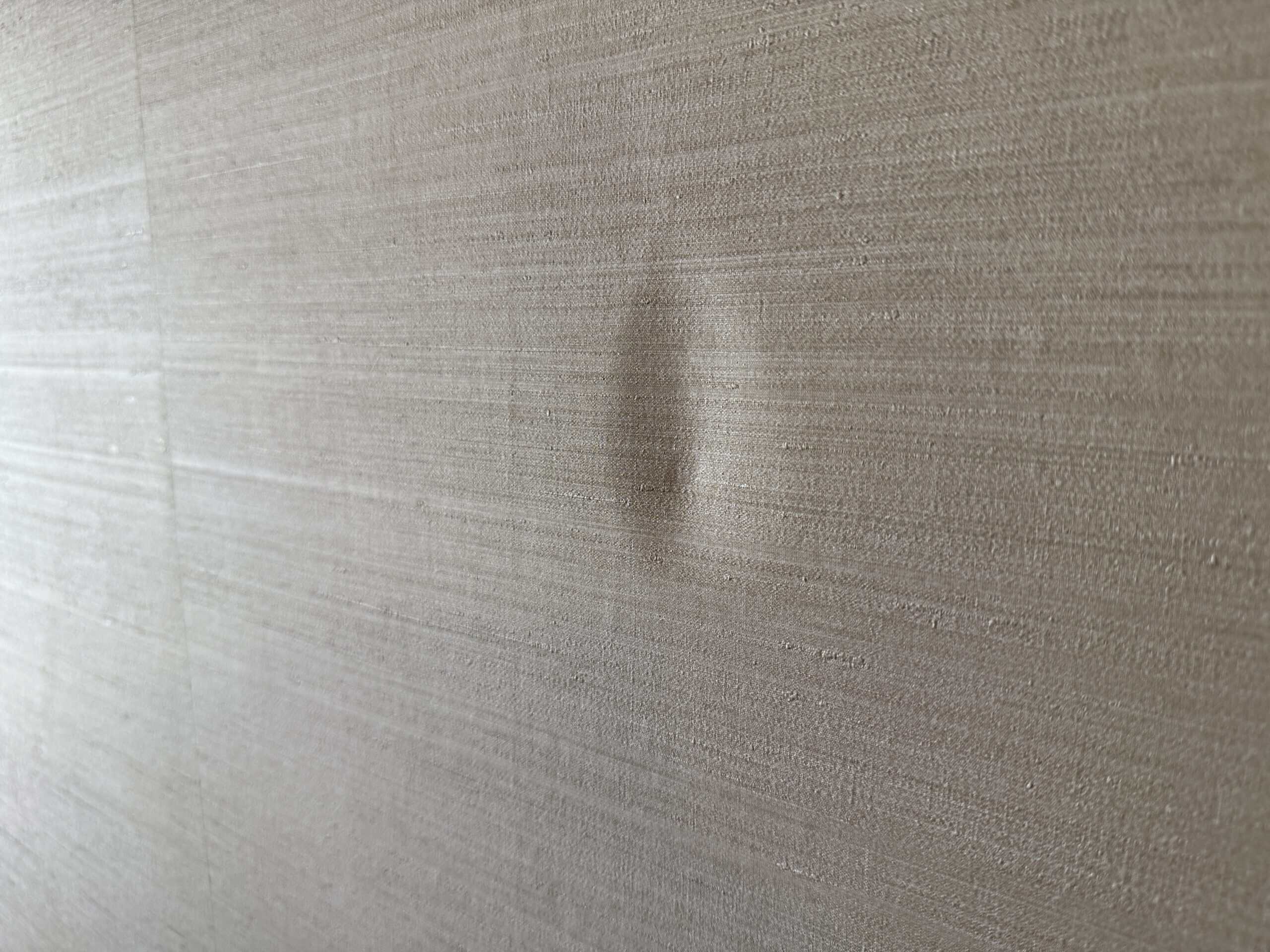 An oval shaped dent in the wall.