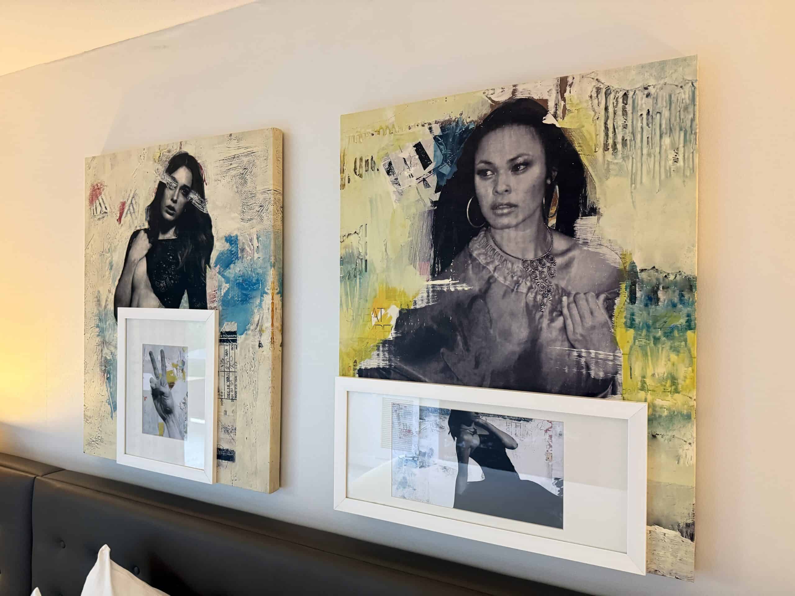 Wall art above the bed, depicting stylish women.
