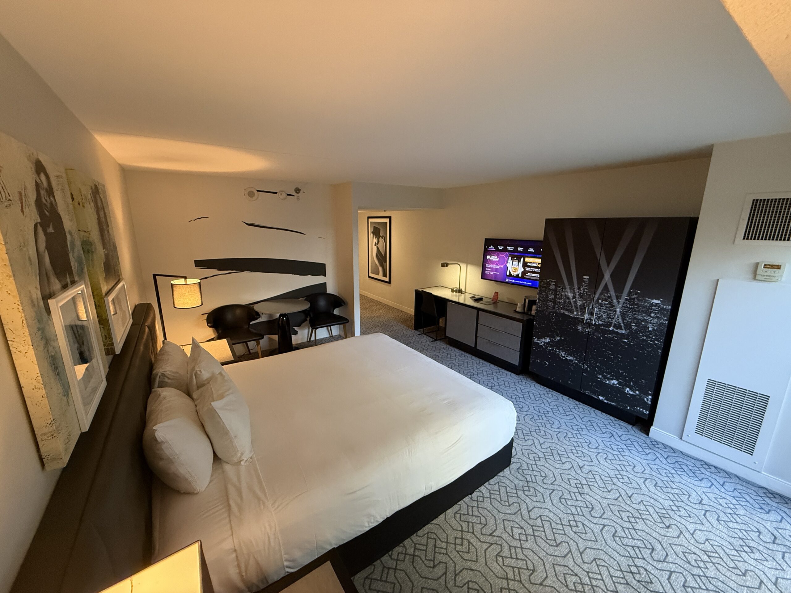Another angle of the room, which shows the bed pointed towards a wall mounted TV.