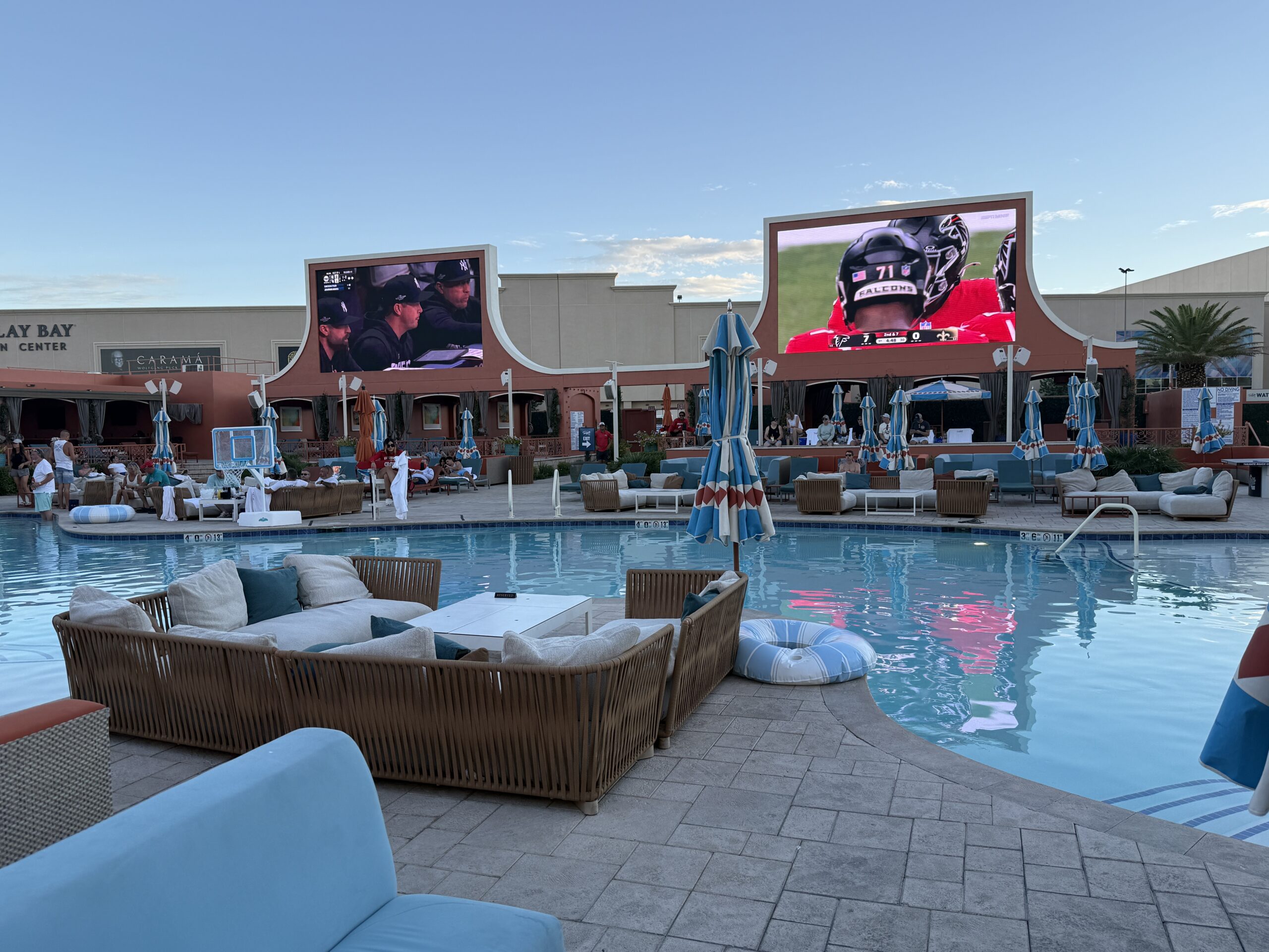 A view of the 2 secondary screens over an empty swimming pool.