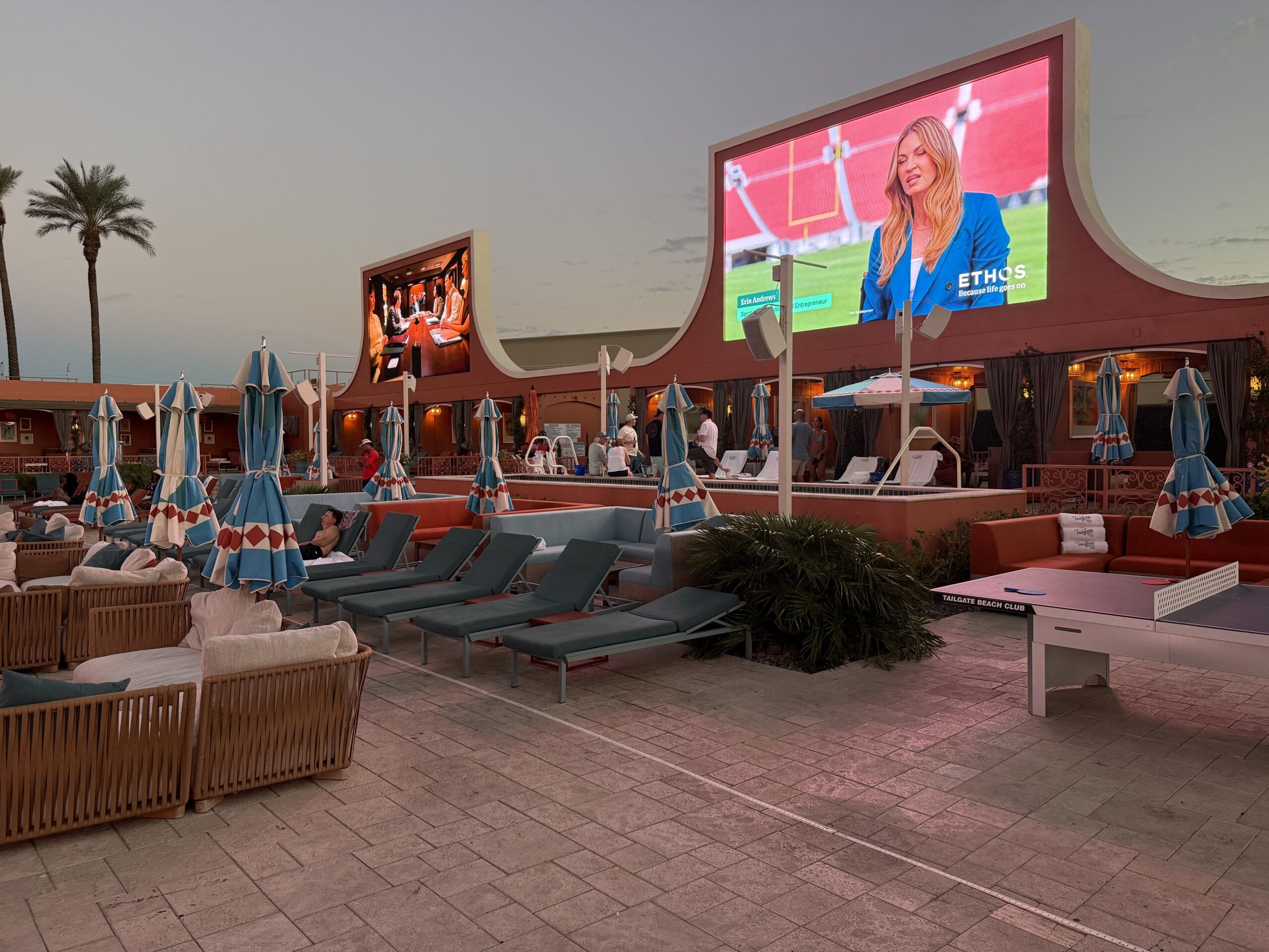 The two secondary screens stand tall over seating below.